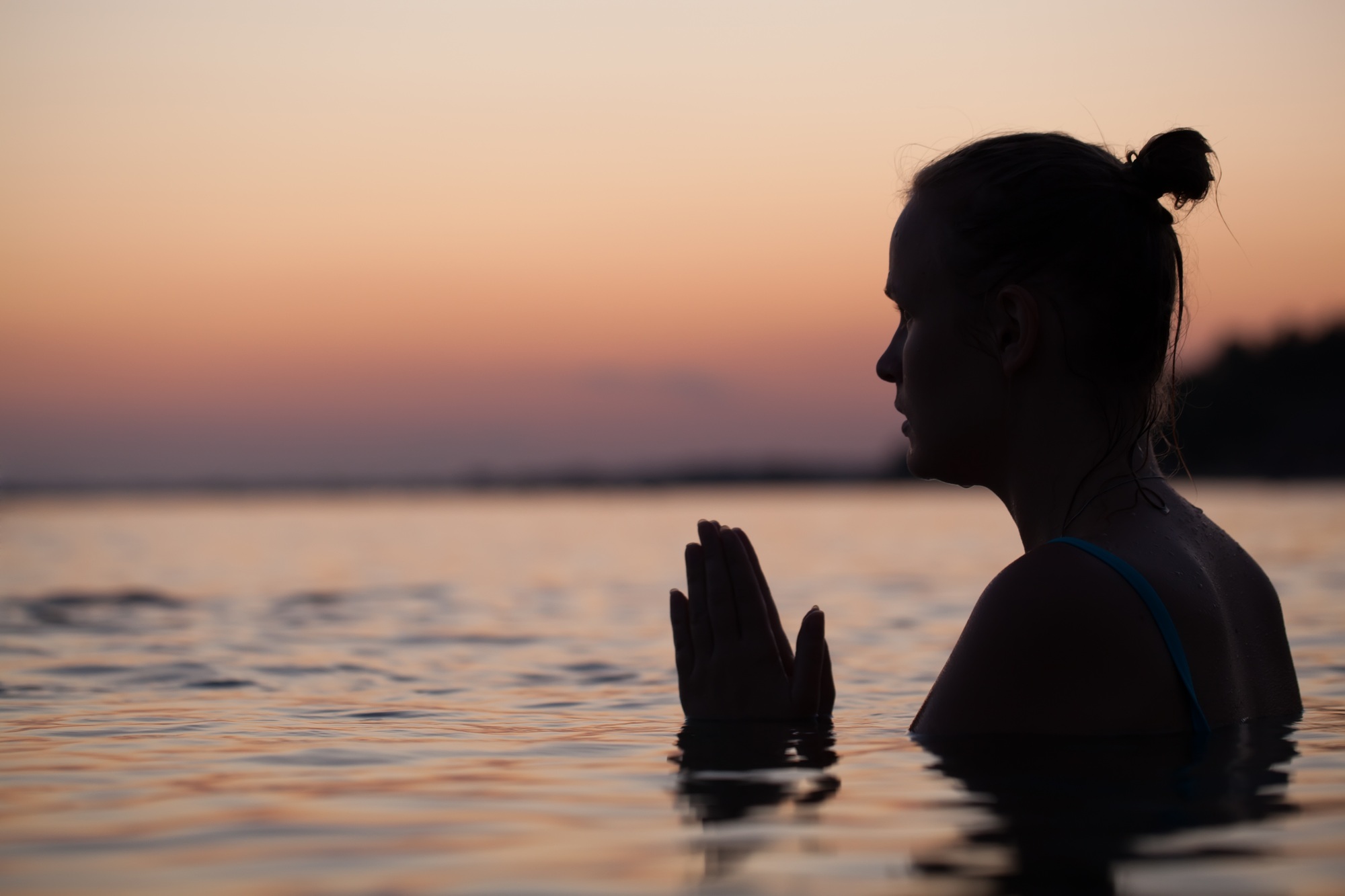 Woman in water during pray or meditation